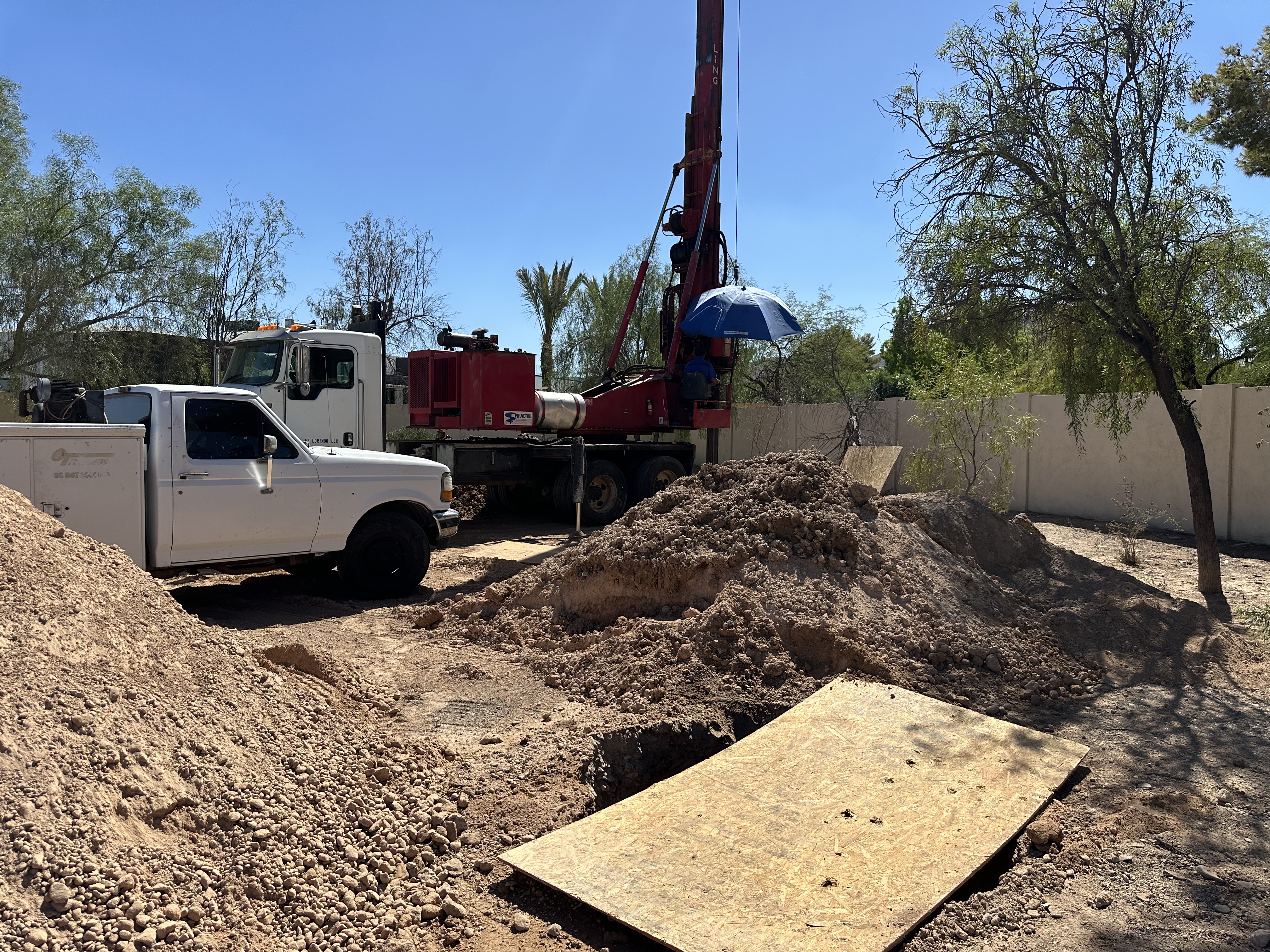 Seepage pit drilling rig operating in Arizona caliche soil