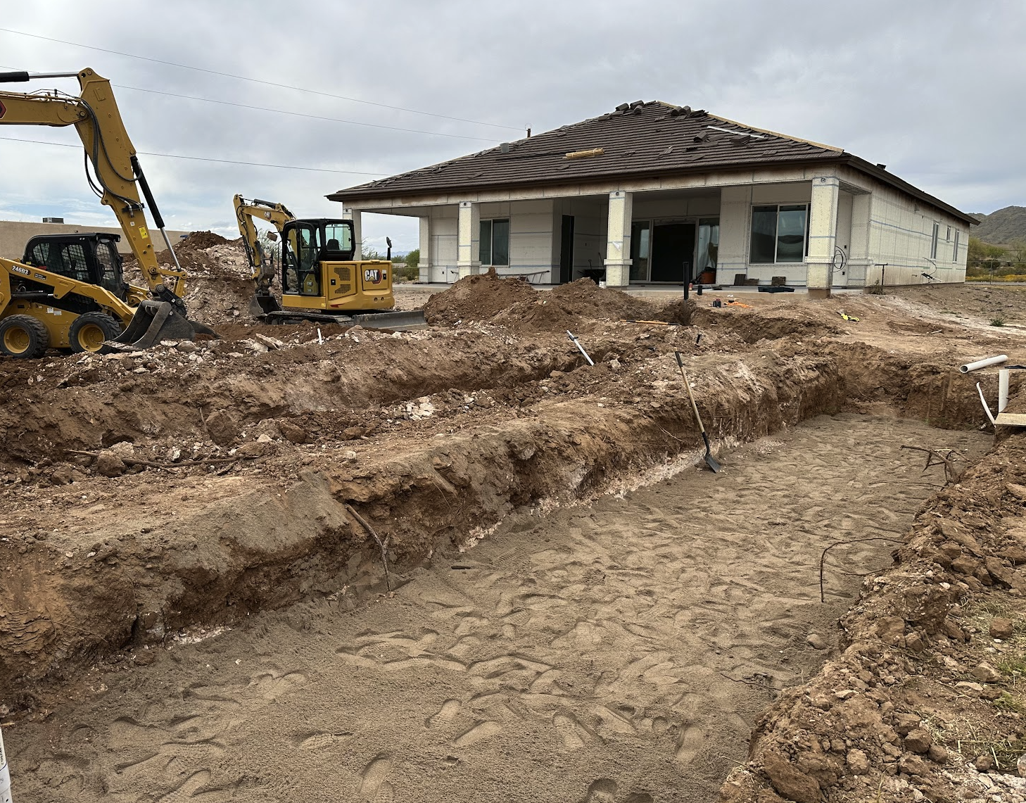 Excavation and site preparation for new septic system installation at a new construction home