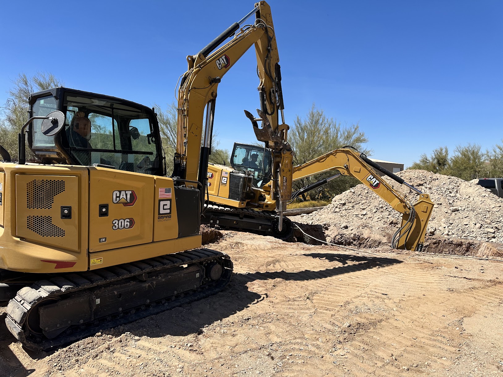 CAT excavators on a septic system installation job site in Phoenix