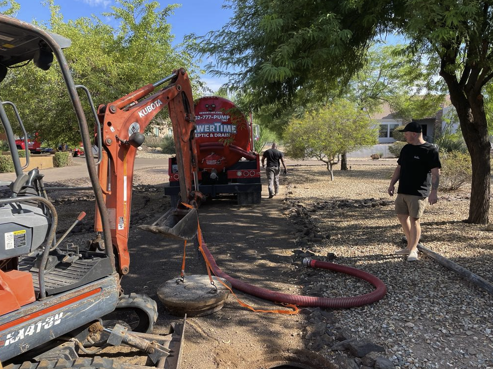 SewerTime pump truck and excavator on a residential septic service call