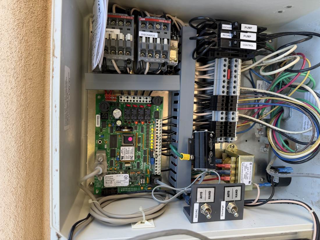 Septic pump control panel with recirc and discharge contactors, pump breakers, and auto-hand switches